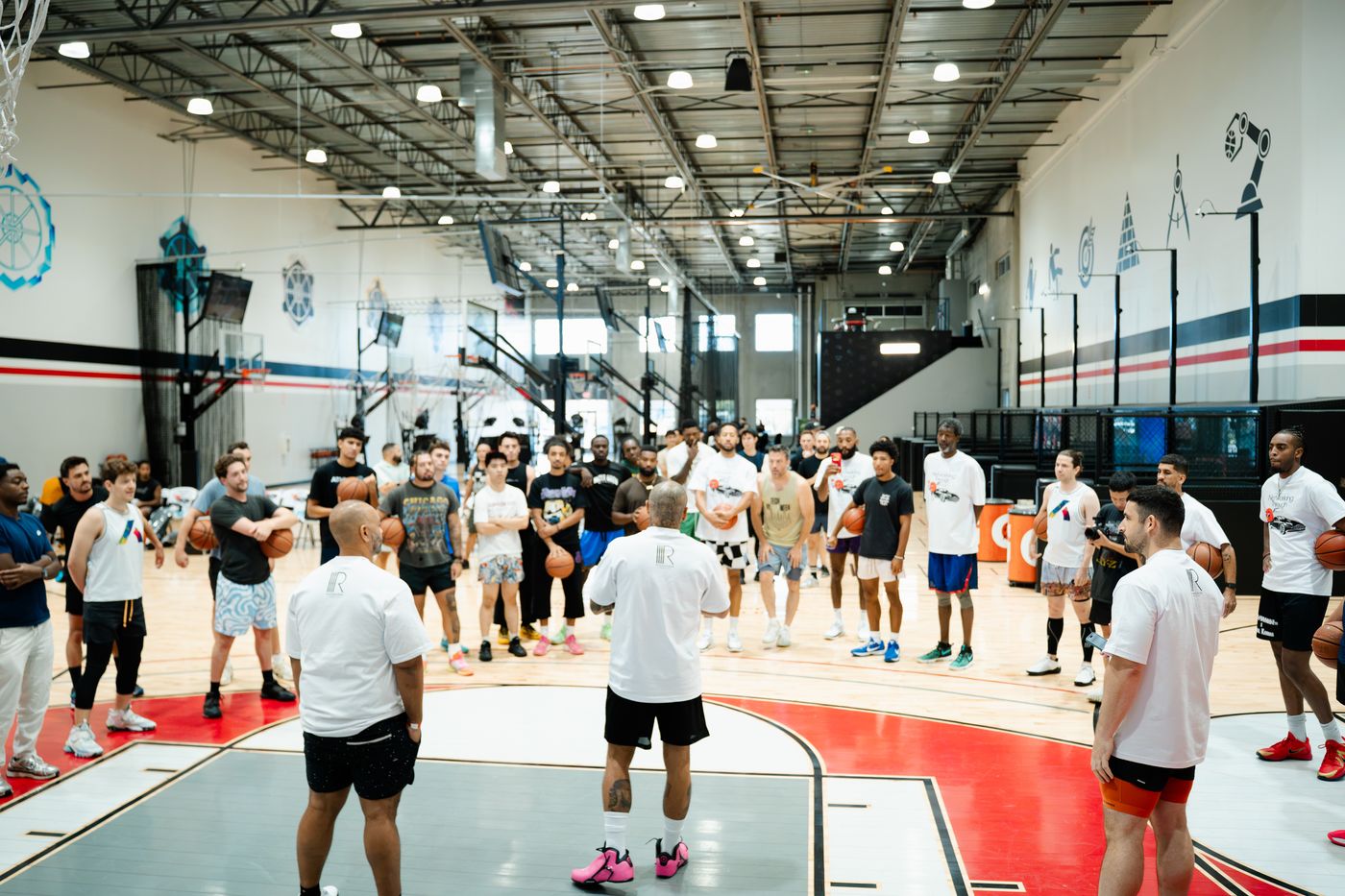 A full court of players gathered in a circle at a B2B Ball run.